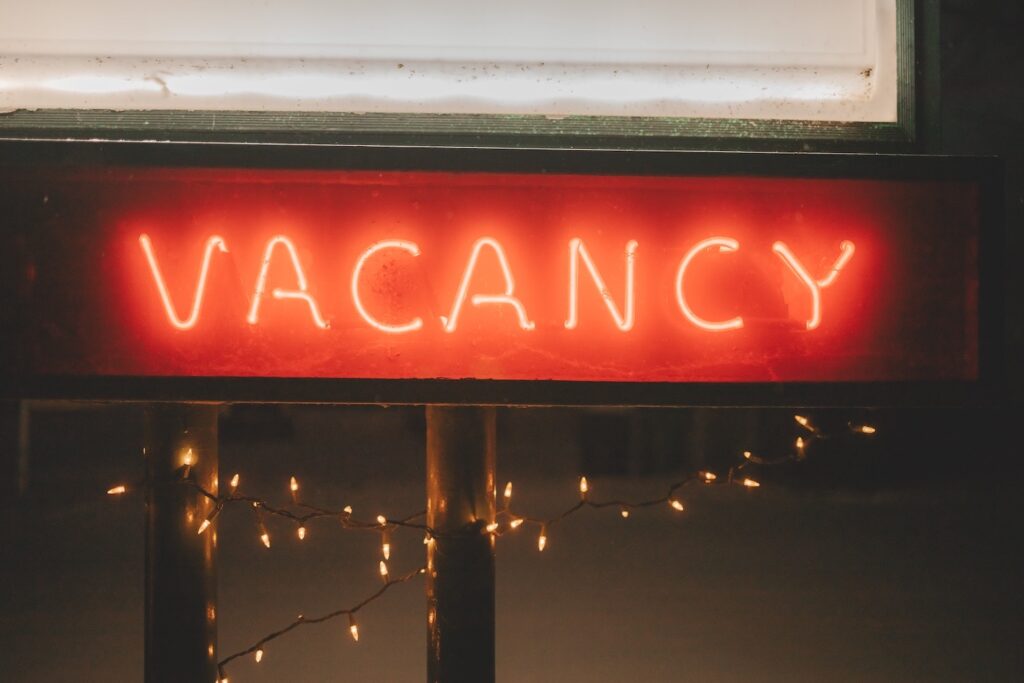 A red neon sign spelling the word VACANCY in capital letters 